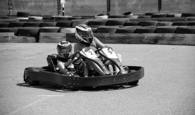 ODESSA, UKRAINE - August 7, 2022: Healthy lifestyle. Sport family. Family vacation at karting track. Children with parents go in for motorsports. Karting. Hobbies, sports education, leisure, lifestyle