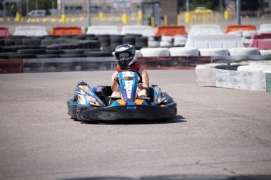 ODESSA, UKRAINE - August 7, 2022: Healthy lifestyle. Sport family. Family vacation at karting track. Children with parents go in for motorsports. Karting. Hobbies, sports education, leisure, lifestyle