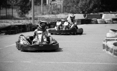 ODESSA, UKRAINE - August 7, 2022: Healthy lifestyle. Sport family. Family vacation at karting track. Children with parents go in for motorsports. Karting. Hobbies, sports education, leisure, lifestyle