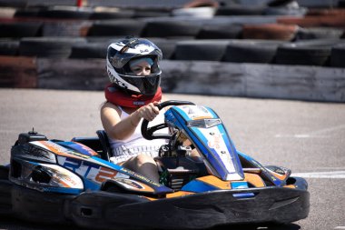 ODESSA, UKRAINE - August 7, 2022: Healthy lifestyle. Sport family. Family vacation at karting track. Children with parents go in for motorsports. Karting. Hobbies, sports education, leisure, lifestyle