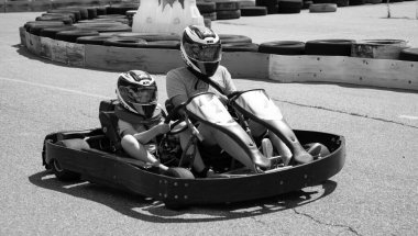 ODESSA, UKRAINE - August 7, 2022: Healthy lifestyle. Sport family. Family vacation at karting track. Children with parents go in for motorsports. Karting. Hobbies, sports education, leisure, lifestyle