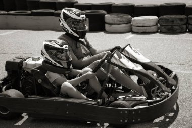 ODESSA, UKRAINE - August 7, 2022: Healthy lifestyle. Sport family. Family vacation at karting track. Children with parents go in for motorsports. Karting. Hobbies, sports education, leisure, lifestyle