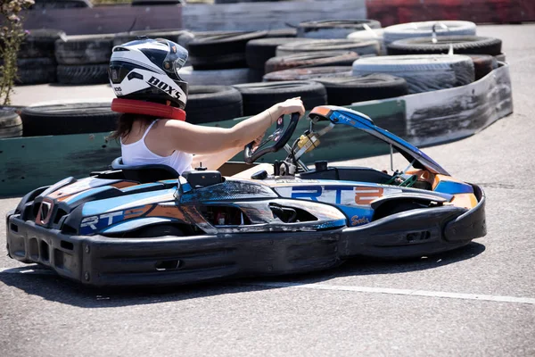 ODESSA, UKRAINE - August 7, 2022: Healthy lifestyle. Sport family. Family vacation at karting track. Children with parents go in for motorsports. Karting. Hobbies, sports education, leisure, lifestyle
