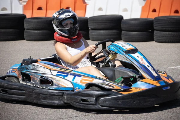 ODESSA, UKRAINE - August 7, 2022: Healthy lifestyle. Sport family. Family vacation at karting track. Children with parents go in for motorsports. Karting. Hobbies, sports education, leisure, lifestyle