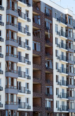Broken windows of residential civilian building after Russian rocket exploded during Russian war against Ukraine. Broken glass windows, broken window frames from explosion. Russian invasion concept
