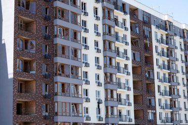 Broken windows of residential civilian building after Russian rocket exploded during Russian war against Ukraine. Broken glass windows, broken window frames from explosion. Russian invasion concept