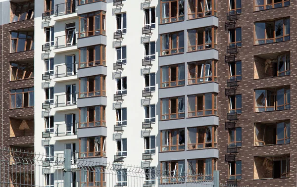 Broken windows of residential civilian building after Russian rocket exploded during Russian war against Ukraine. Broken glass windows, broken window frames from explosion. Russian invasion concept