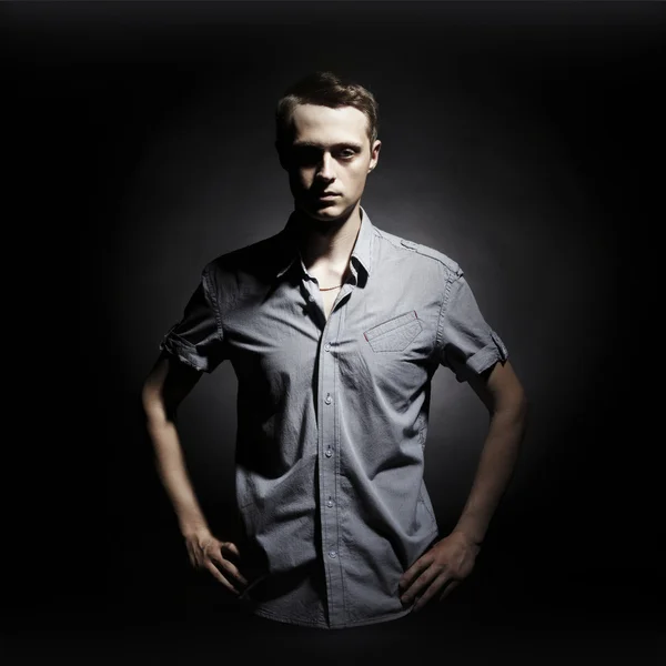 Portrait of a young man against black background — Stock Photo, Image