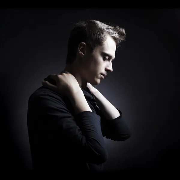 Portrait of a young beautyful stylish man against black background — Stock Photo, Image