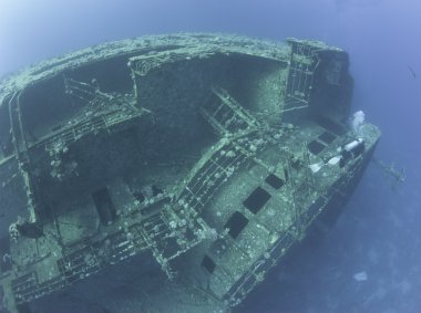 Scuba diver exploring a shipwreck clipart