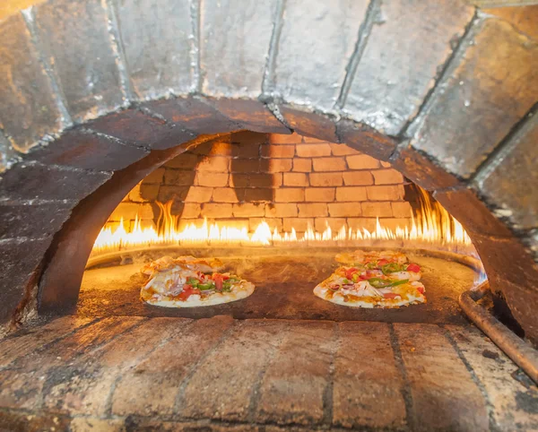 Pizzas cooking in an open oven — Stock Photo, Image