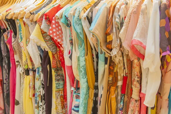Womens summer clothes hanging on rail — Stock Photo, Image