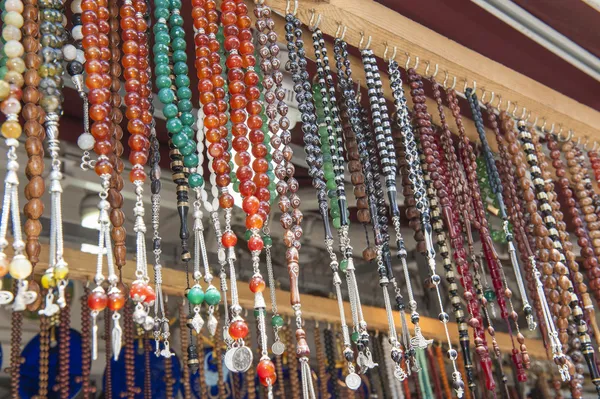 Ornate jewelry hanging at market stall — Stock Photo, Image
