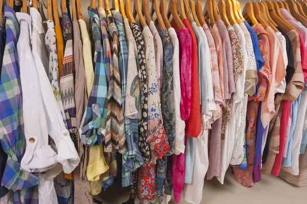 Womens clothes hanging on rail — Stock Photo, Image