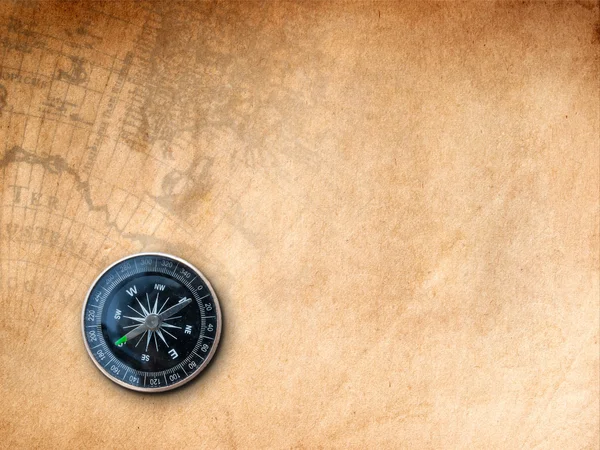Svart kompass på brunt papper — Stockfoto