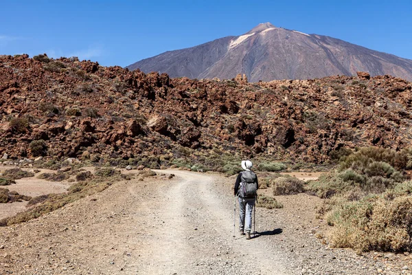 Taş yolda yürüyen bir kadın.