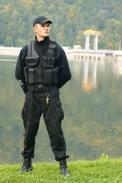 Security guard in uniform and armed — Stock Photo, Image