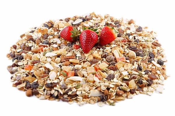 Breakfast cereals and Strawberries, oatmeal with strawberries, candied fruits, raisins and nuts, as background