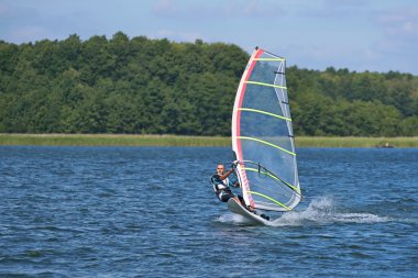 Windsurfing on the lake Nieslysz, Poland clipart