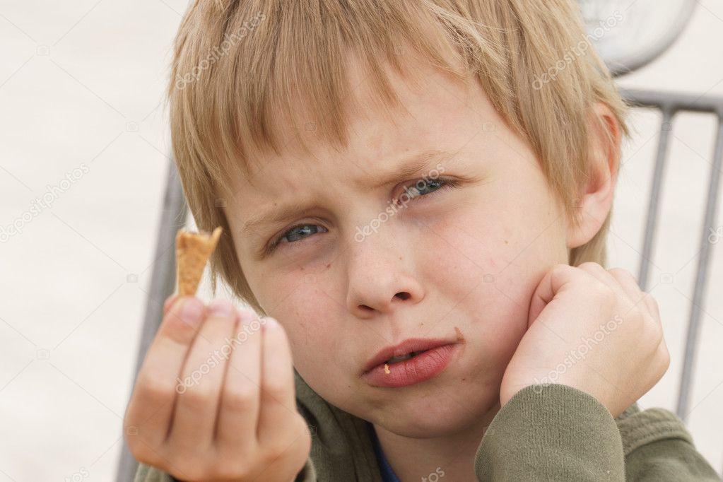 Boy eating ice cream, who present disappointment because of that I ate it asks for the next