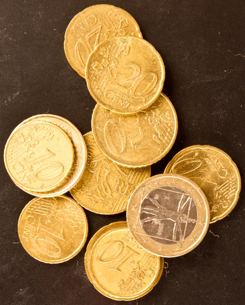 Euro coins on dirty dark background — Stock Photo, Image