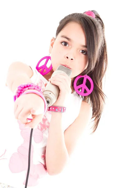 Girl singing with microphone pointing at you — Stock Photo, Image