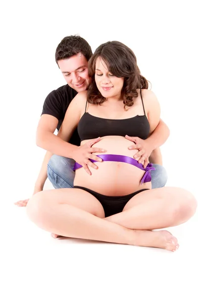 Pregnant couple sitting on the floor — Stock Photo, Image