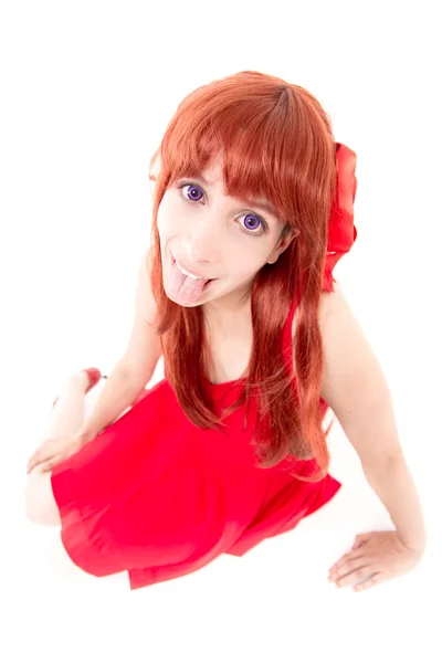Jonge vrouw in rode jurk met tong uit — Stockfoto