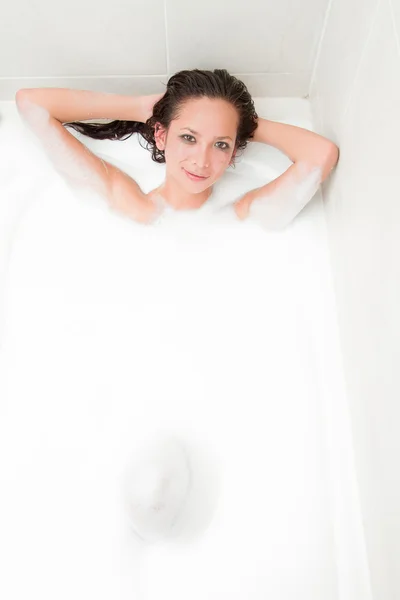 Young attractive woman relaxing in a bubble bath — Stock Photo, Image