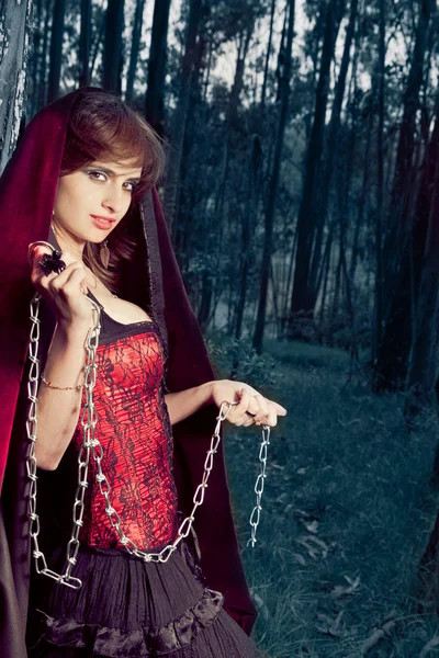 Seductive woman in a corset standing in a forest — Stock Photo, Image
