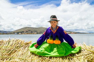 Sitting girl on a floating Uros island, Titicaca clipart