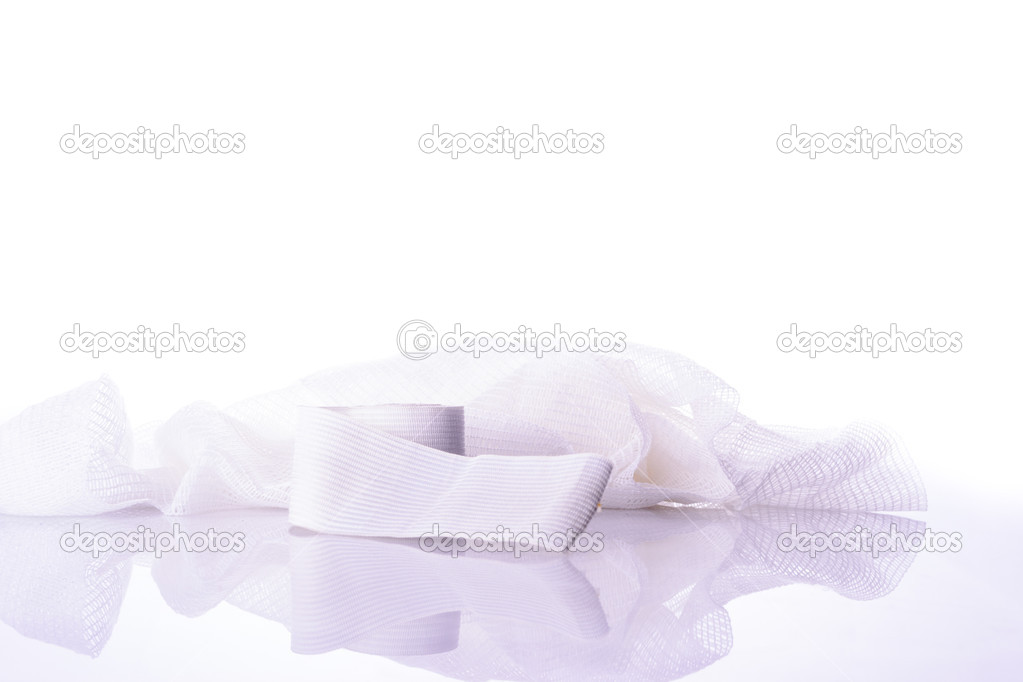 White medical cotton gauze bandage on white