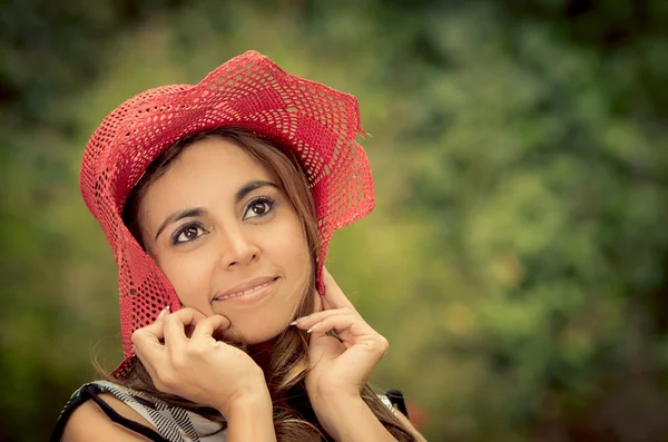 Portrait of beautiful woman holding her hat down — Stock Photo, Image