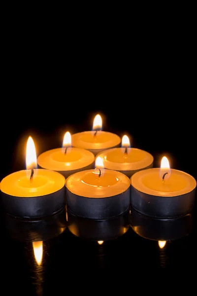 Candle triangle on a black background — Stock Photo, Image