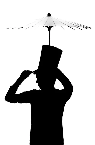 Silhouette di un uomo con un cappello con un ombrello . — Foto Stock