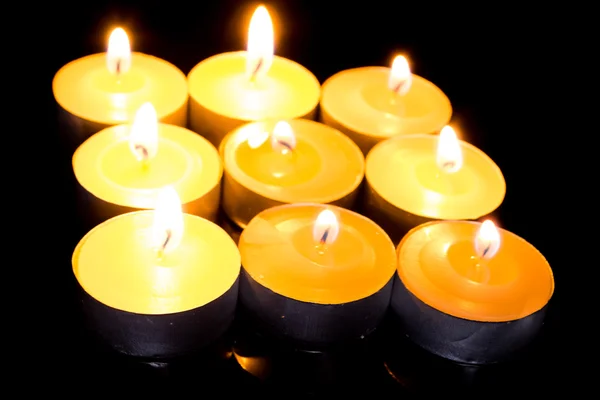 Group of burning candles on black background. — Stock Photo, Image