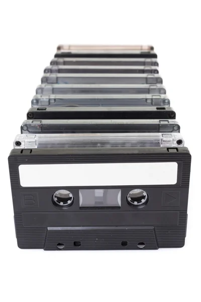 Row of vintage audio tapes over white background — Stock Photo, Image