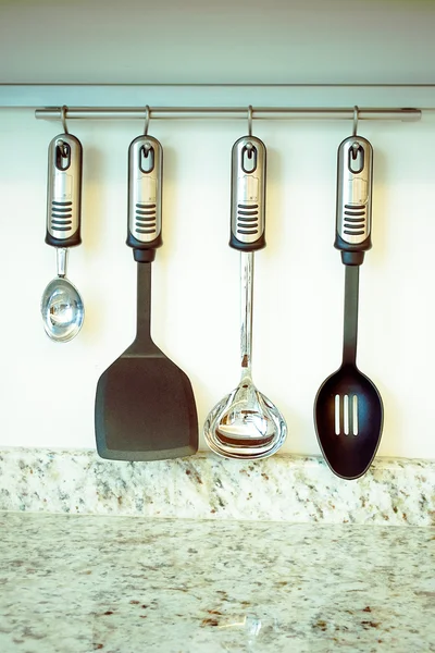 Set of kitchen utensils hanging on the wall — Stock Photo, Image