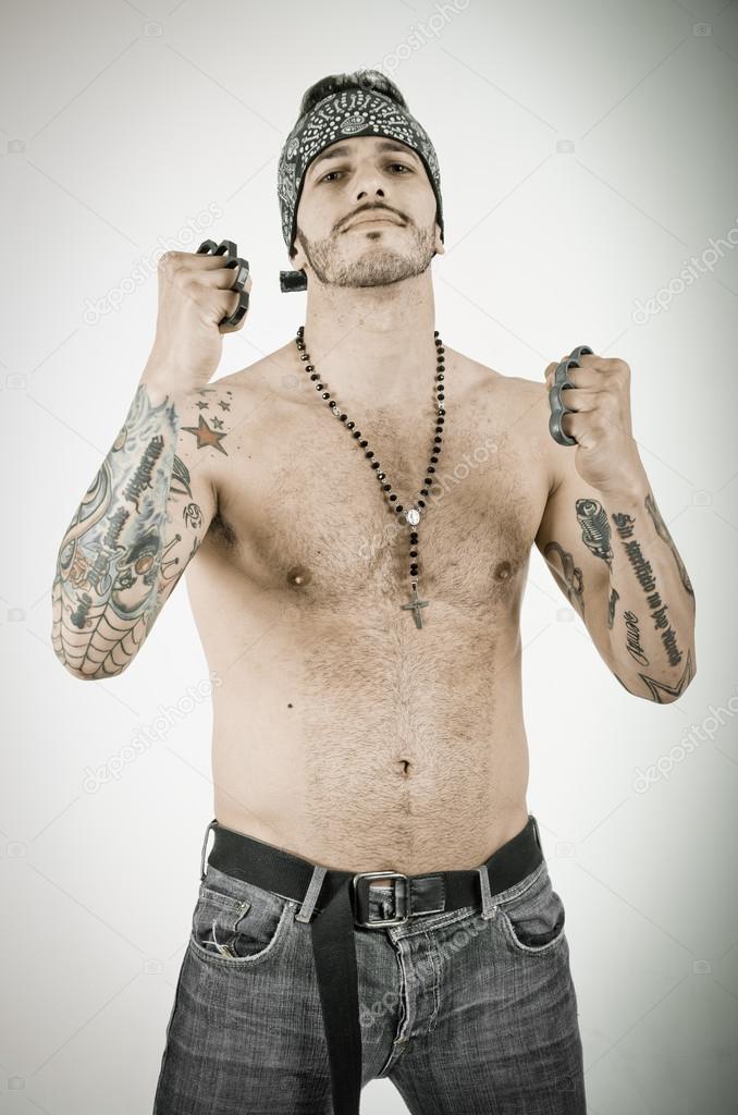 Man with brass knuckles in grunge background