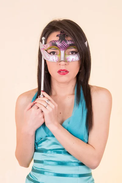 Beautiful young woman with mysterious mask. — Stock Photo, Image