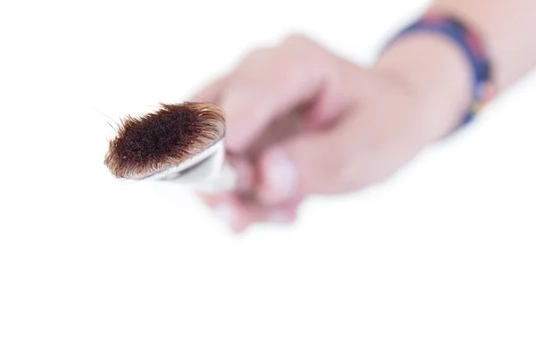 Brush in hand on white background — Stock Photo, Image