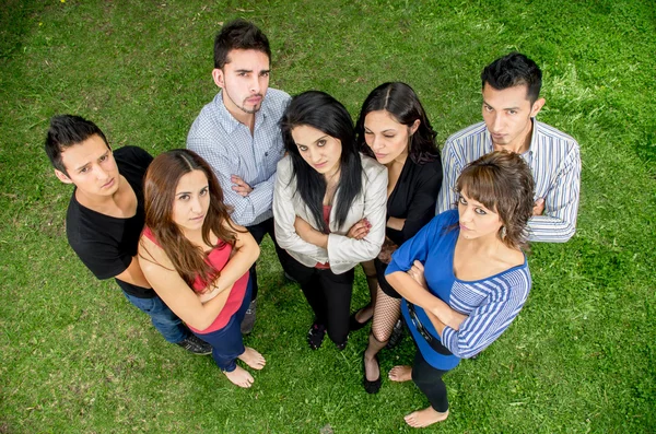 Grupo de jovens hispânicos sérios no parque — Fotografia de Stock