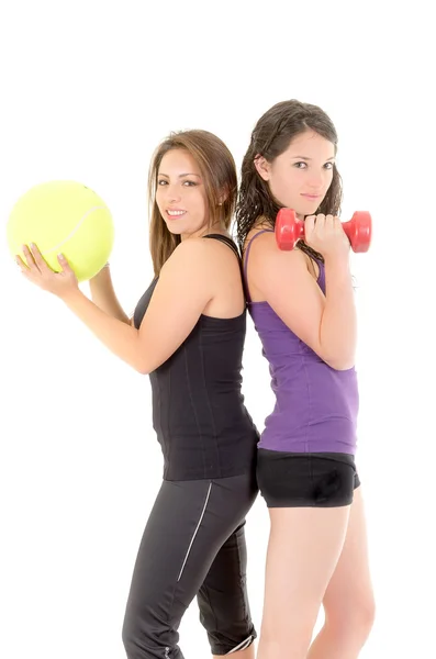 Two women doing exercises with barbell and ball — Stock Photo, Image