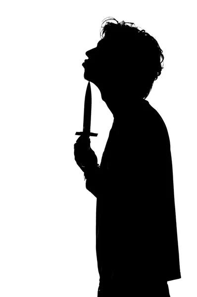 Silhouette of a man attempting suicide knife — Stock Photo, Image