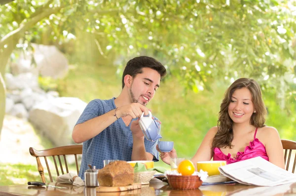 Happy, attractive couple eats breakfast together — Stock Photo, Image