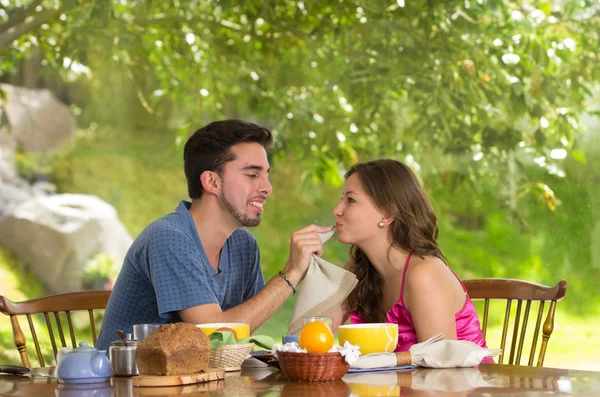 Happy, attractive couple eats breakfast together — Stock Photo, Image