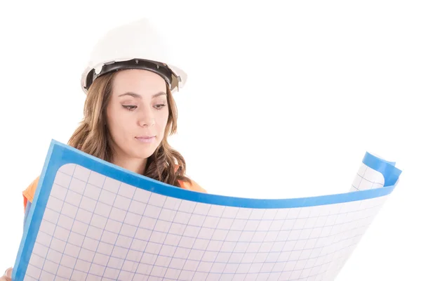 Female construction worker reading blue prints — Stock Photo, Image