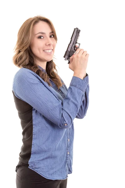 Молода брюнетка з пістолетом ізольована на білому — стокове фото