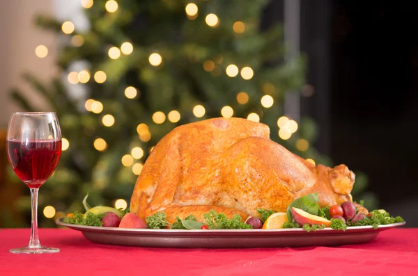 Garnished roasted turkey on holiday with red wine — Stock Photo, Image