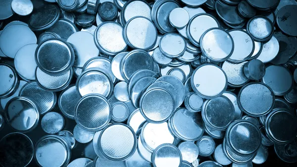 Lithium batteries of various sizes background blue toned — Stock Photo, Image